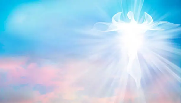Photo of Archangel. Heavenly angelic spirit with wings. Illustration abstract white angel. Belief. Afterlife. Spiritual Angel. Blessing. Sky clouds with bright light rays. Heaven. Faith. Web banner
