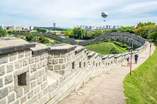 Hwaseong fortress fortification wall view and city in background in Suwon South Korea