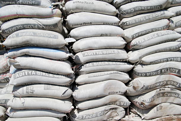 A heap of cement bags, lying on a road side near Mhatre bridge, Pune, Maharashtra, India. A heap of cement bags, lying on a road side near Mhatre bridge, Pune, Maharashtra, India. cement bag stock pictures, royalty-free photos & images