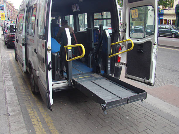 Wheelchair Ramp in a Bus in Ireland Dublin, Ireland - May 17, 2008: Wheelchair lift for a bus in Dublin, Ireland. The vehicle is equipped with a special wheelchair lift on the backside of the bus. This is important equipment for many bus operators and helps a lot of people with physical disabilities. wheelchair lift stock pictures, royalty-free photos & images