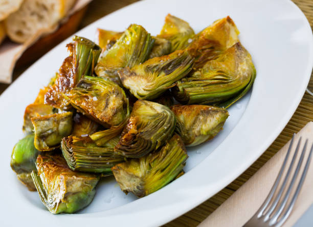 istock Delicious fried artichoke halves on a white plate 1181621400