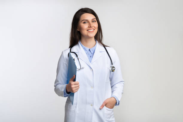 istock Doctor Lady Smiling At Camera Standing Over Gray Studio Background 1181621460