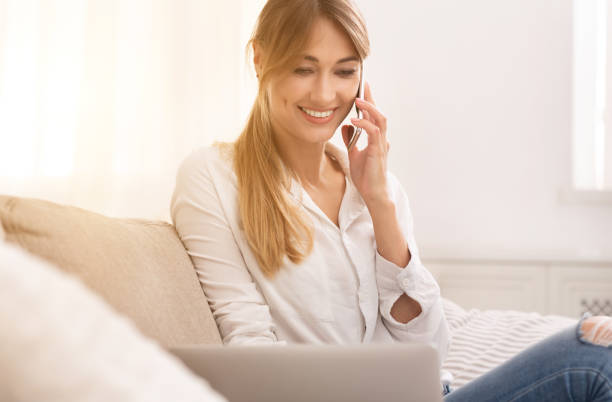 istock Happy Woman Having Phone Conversation Sitting On Sofa At Home 1181621586