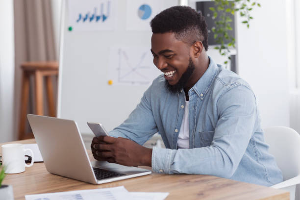 istock Cheerful employee browsing internet on smartphone, having break at work 1181621717