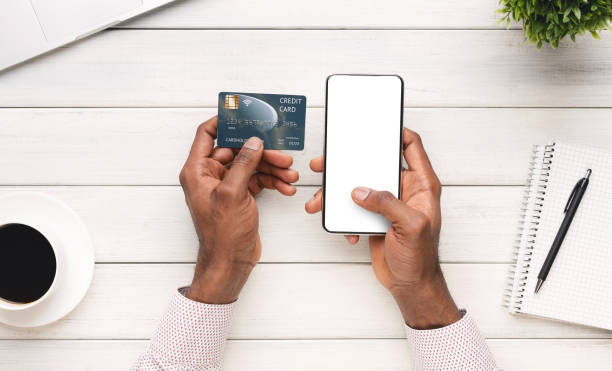istock Businessman paying his bills online using smartphone with blank screen 1181621760