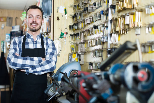 istock Adult worker showing his tools for making keys 1181621834