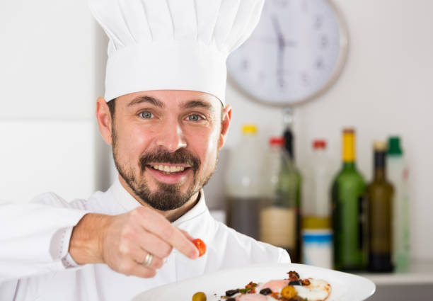 istock Male cook preparing food 1181622575