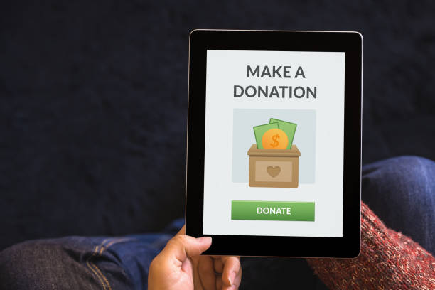 istock Hands holding tablet with donation concept on screen 1181623051