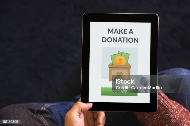 Hands Holding Tablet With Donation Concept On Screen Stock Photo - Download Image Now