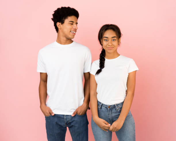 istock Guy looking at girl, posing together on pink background 1181623895