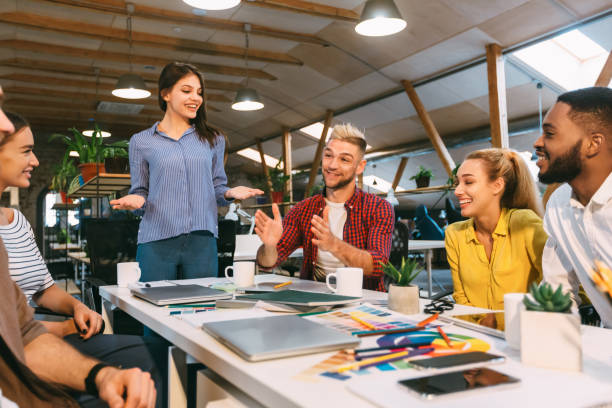 istock Group of designers discussing affairs, working in modern office 1181623948
