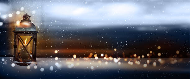 Burning lantern in snowy winter Burning christmas lantern in a snowy winter landscape with magical lights for a background lanterns at night stock pictures, royalty-free photos & images
