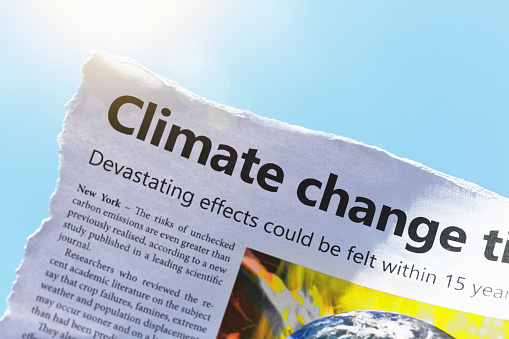 Dummy newspaper cutting sound the alarm on global warming.