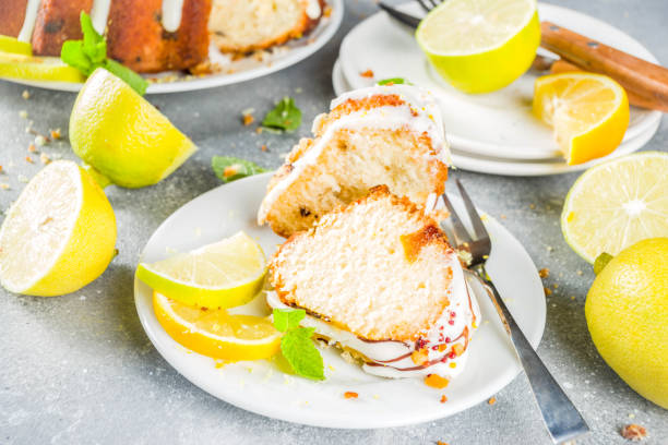 Homemade lemon bundt cake with sugar icing, fresh lemons and mint leaves, copy space