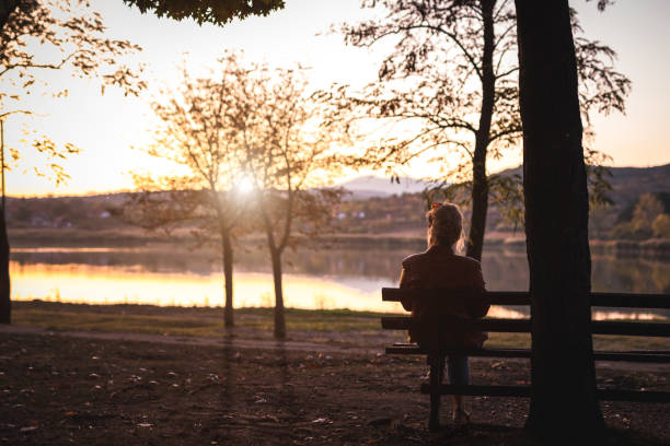 istock Woman enjoying in autumn sunset 1181628732