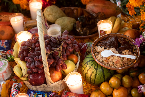 Tzintzuntzan, 11/01/2018: Detail of offering on tomb in the cemetery located in Tzintzuntzan in the Pátzcuaro region, in the Mexican state of Michoacán. On November 1st and 2nd, the local community gathers in the cemetery to celebrate Day of the Dead, when, according to Mexican belief, the souls of the dead return to visit their families. During the celebration the tombs are adorned with flowers, candles and the favorite foods of the deceased as a way to welcome their souls in a joyful way.