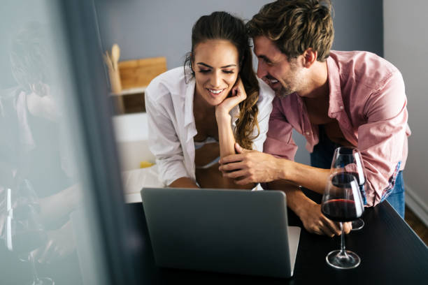 istock Happy smiling couple using laptop at home 1181629331
