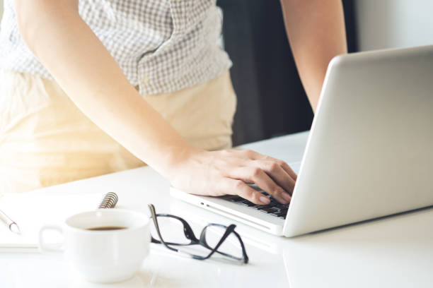 istock Man is typing on laptop computer keyboard in the office with sun light. 1181632943