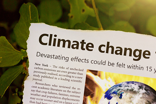 Dummy newspaper cutting sound the alarm on global warming.