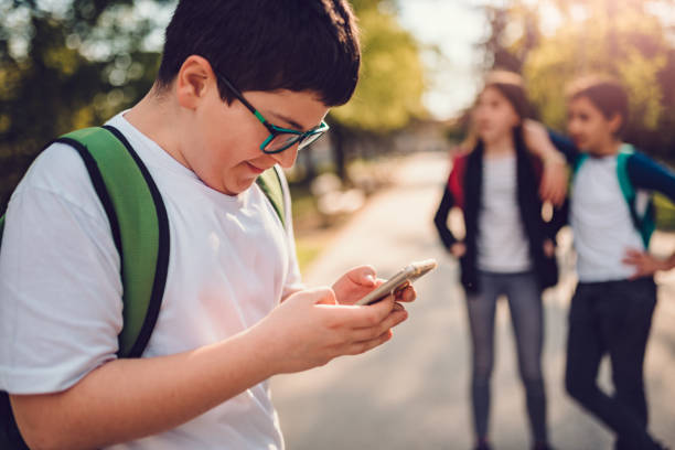 istock Boy standing at schoolyard cyberbullying 1181634874