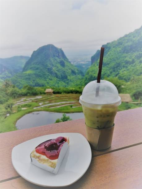 Cake Strawberry and green tea with  in the beautiful sky of mountains,A backdrop with mountains and forests traveling on holiday concept.
