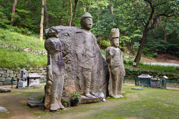 Japanese little statues known as Jizo or the honorific wear redknit cap along pathway in Sainokawara Park hot spring in Kusatsu Onsen,Japan.