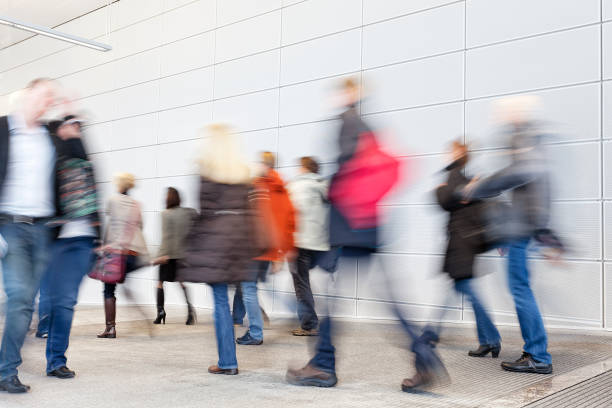 istock Businesspeople Walking Through White Hallway 1181636673