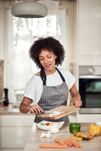 istock Woman putting mushrooms into bowl. 1181639204