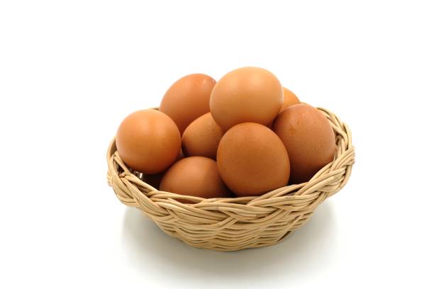 istock Many eggs in a wooden basket on white background 1181639603