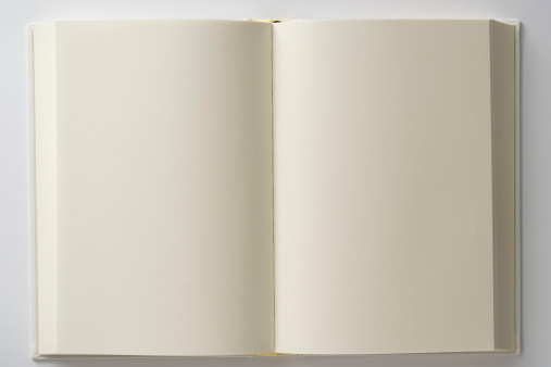 Opened blank white book isolated on white background.
