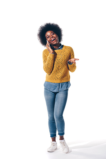 cheerful african american girl talking on smartphone, isolated on white