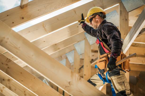 Wooden Frame Contractor Construction Worker on Duty. Caucasian Contractor and the Wooden House Frame. Industrial Theme. carpentry stock pictures, royalty-free photos & images