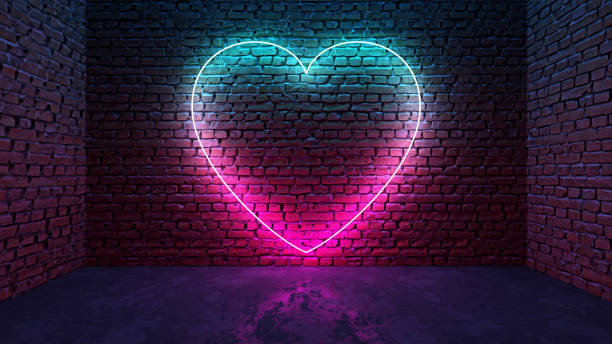 светящееся неоновое сердце в форме иконы на кирпичной стене в темной комнате - brick dancing стоковые фото и изображения