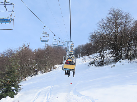 Cerro Campanario, Bariloche, Argentina - July 25, 2019: Cable car leading through the winter forest during a snowy day in Cerro Campanario, Bariloche, Argentina. Cerro Campanario is popular tourist resort in national park Nahuel Huapi in Argentina.