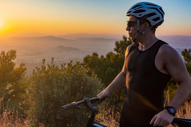 istock Male biker watching the sunset 1181646649