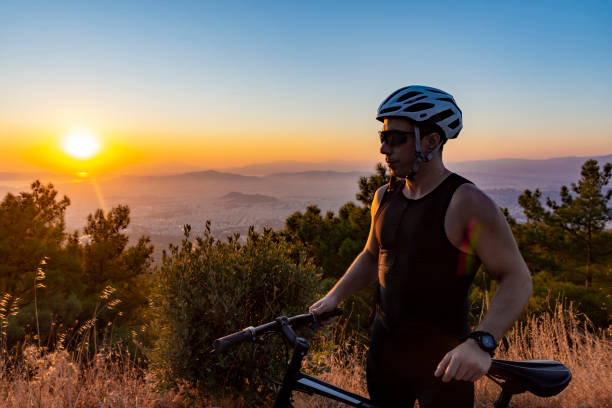 istock Male biker watching the sunset 1181646798
