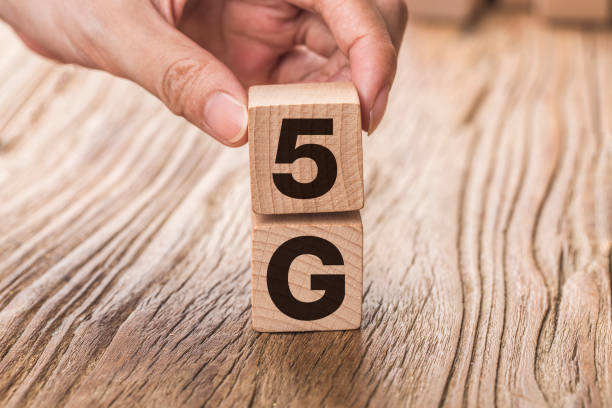 istock 5G (5th Generation) network connecting technology future global. Hand flip wood cube change number 4G to 5G 1181651592