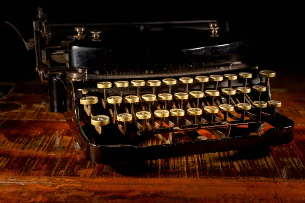 Detail of a historic dusty portable typewriter made in Germany during the twenties of the 20th century.