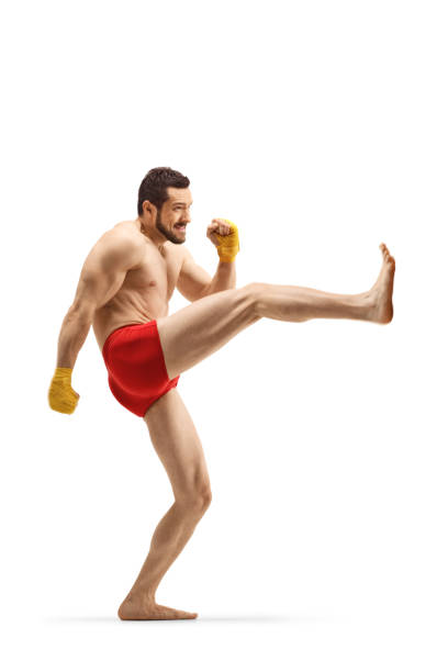 istock Fit man exercising kickboxing and pushing with his leg 1181653178