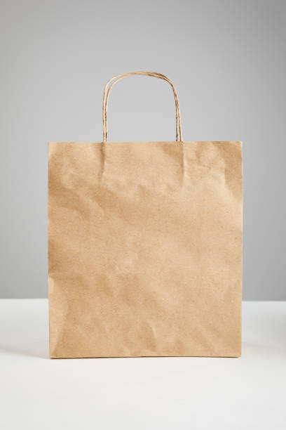 istock paper shopping bag isolated on grey, black Friday concept 1181653299