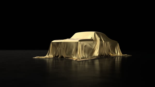 Old sports car covered with gold cloth.