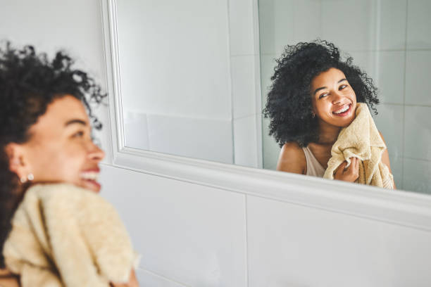 Fresh faced and glowing Shot of an attractive young woman wiping her face with a towel inside her bathroom at home woman washing face stock pictures, royalty-free photos & images