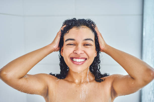 I'm having a fresh start to the day Portrait of an attractive young woman taking a shower inside her bathroom at home wet hair stock pictures, royalty-free photos & images