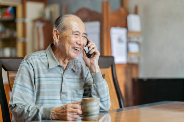 istock Portrait of senior man while talking on smart phone happily 1181654189