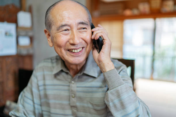 Portrait of senior man while talking on smart phone happily