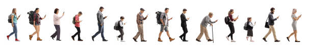 istock Long queue of people walking and using mobile phones 1181655452