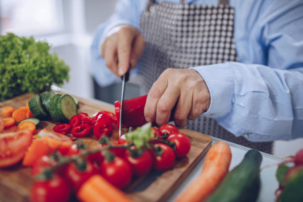istock Chef's hands are cutting vegetables 1181655520