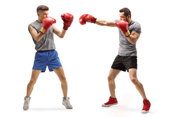 istock Two young men fighting with boxing gloves 1181655580