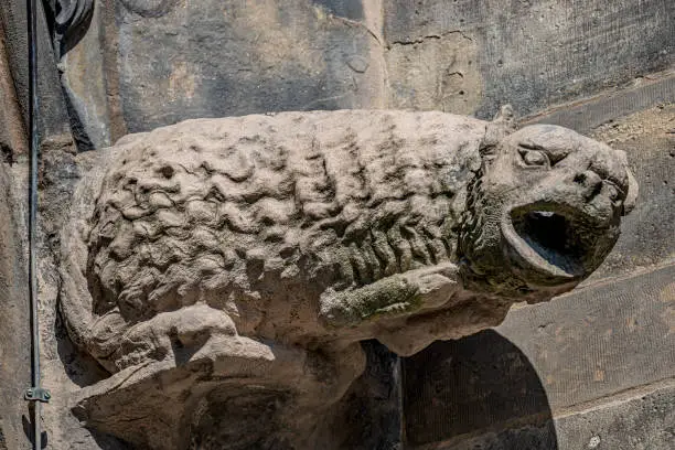 Photo of Old roof figures of scary gargoyles at main facade of cathedral in Magdeburg, Germany, closeup, details