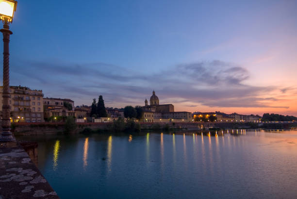 istock sunset and streetlamp at river arno 1181657077